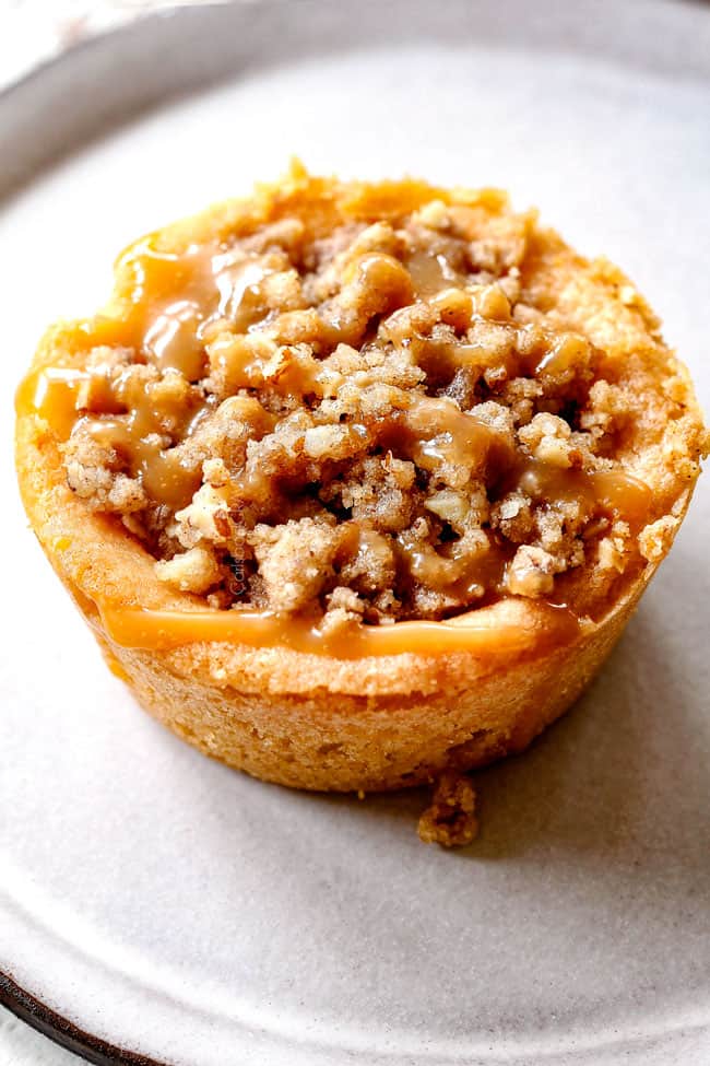 up close of easy caramel apple pie with streusel topping drizzled with salted caramel