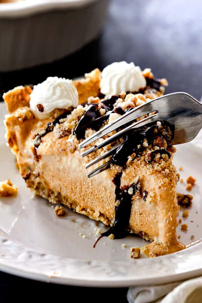 taking a bite of ice cream pie with vanilla ice cream, pure pumpkin and chocolate sauce