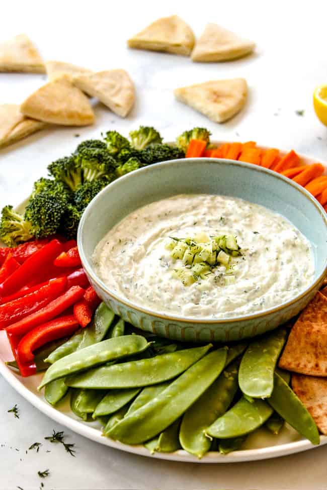 Tzatziki dip surrounded by veggies 