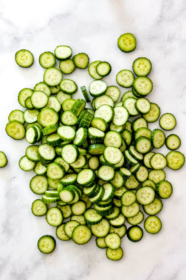 top view of showing how to make cucumber dill salad by chopping cucumbers