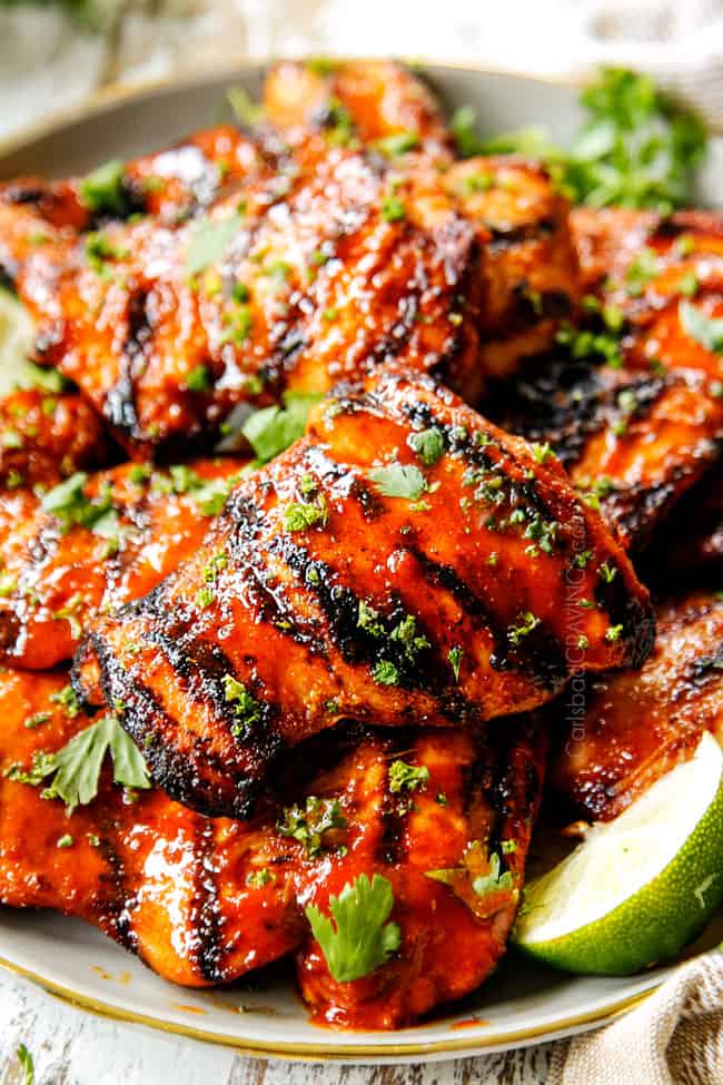 up close of Honey Sriracha Chicken recipe with grill marks garnished with cilantro 