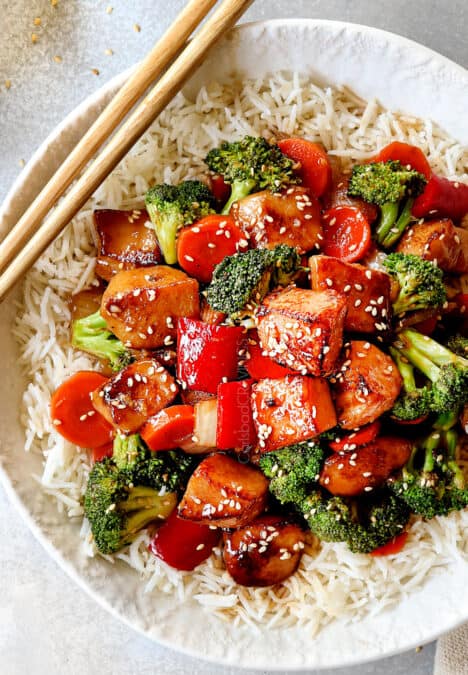 top view of Chinese honey garlic chicken served over rice garnished with sesame seeds