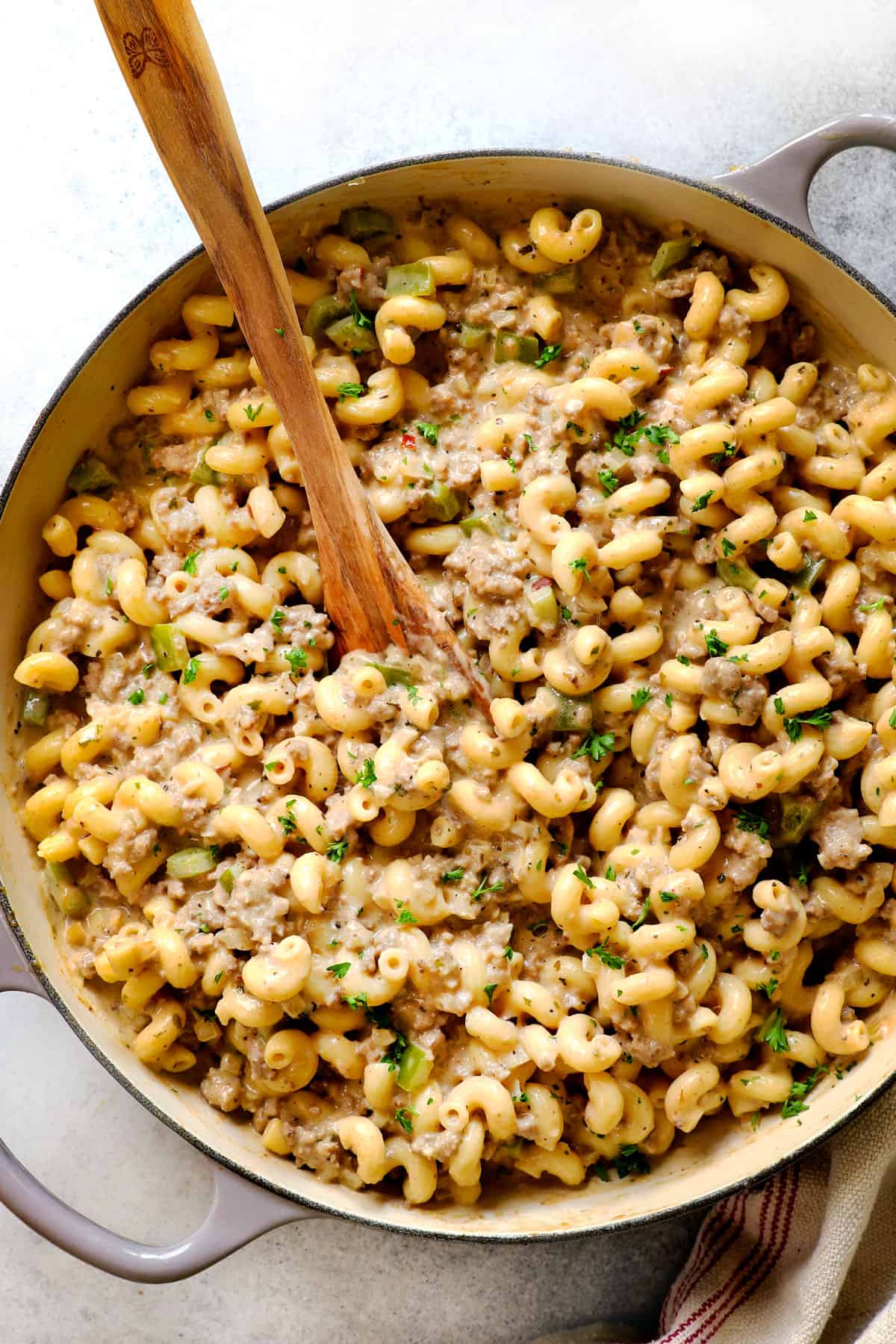 top view of serving Philly Cheesesteak Style Ground Beef Pasta in a large pan garnished with parsley