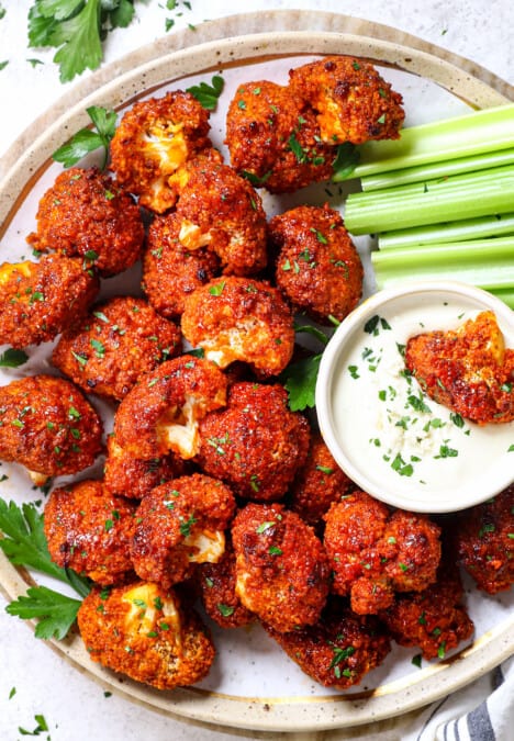 top view of serving buffalo cauliflower on a plate garnished by parsley