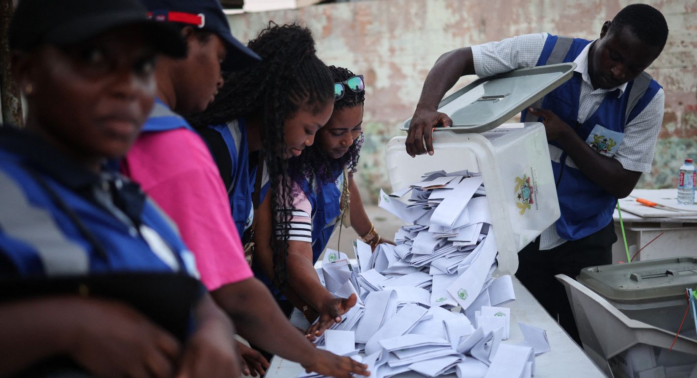 people at a table counting ballots