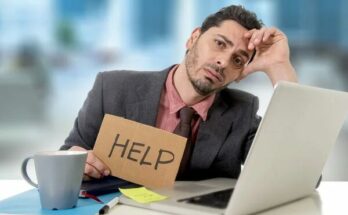 sad businessman at office desk