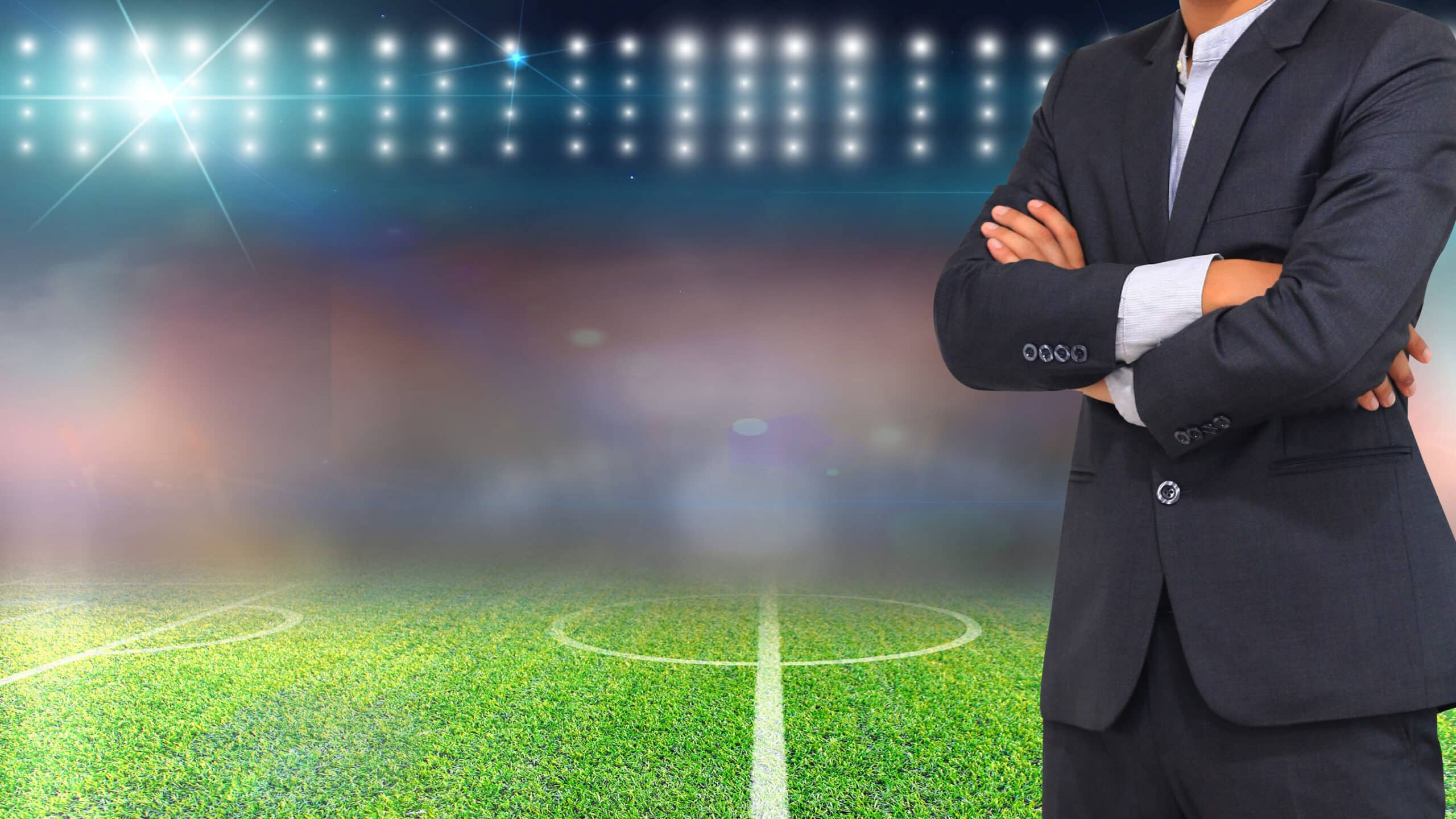 Football manager with soccer field and bright spotlights.