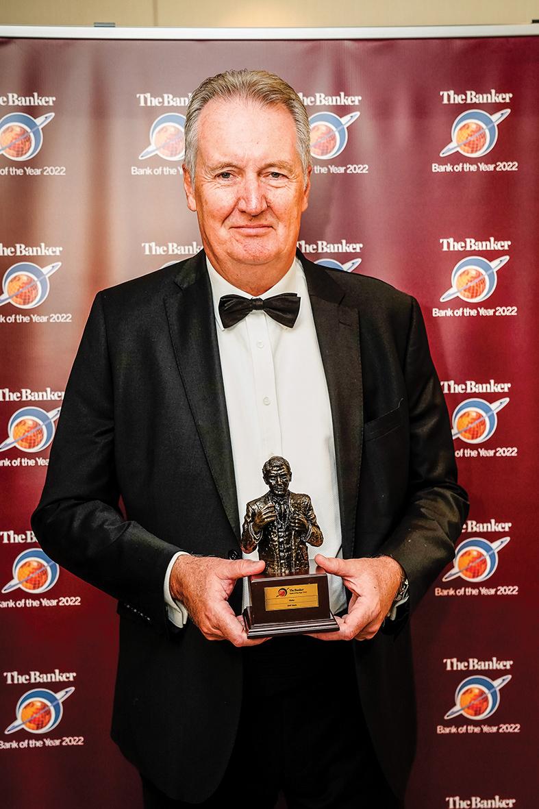 BNF Bank CEO and managing director Michael Collis holding the award in London.