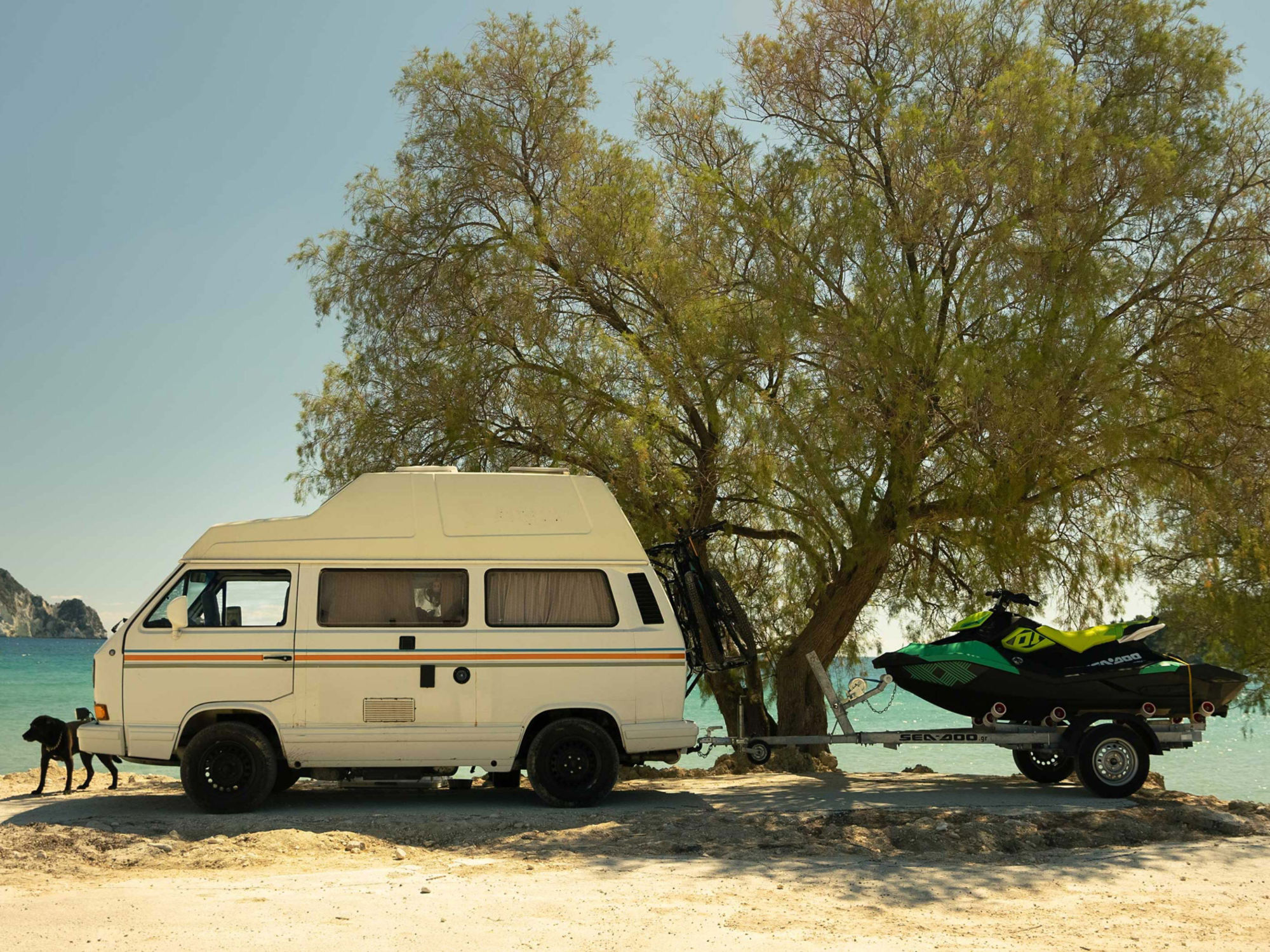 Van with a Sea-Doo next to a beach