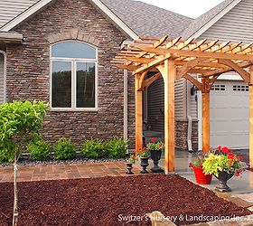 custom cedar arbor enhances home s front entrance and paver patio provides sitting, The arbors height helps in creating a human scale at the entrance