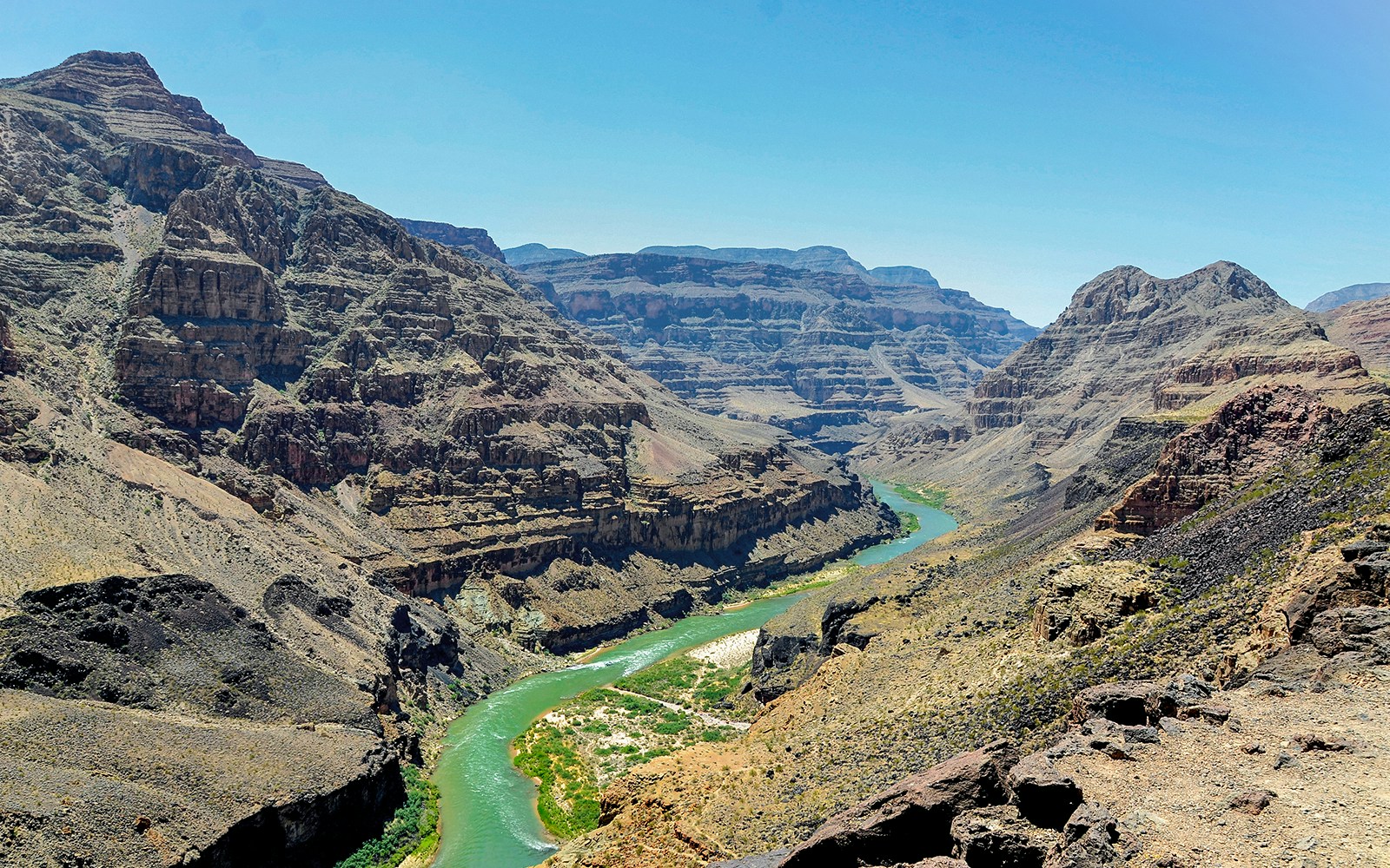 Helicopter view of North Grand Canyon during an air and ground tour departing from Las Vegas, showcasing the vast desert landscape and rugged cliffs