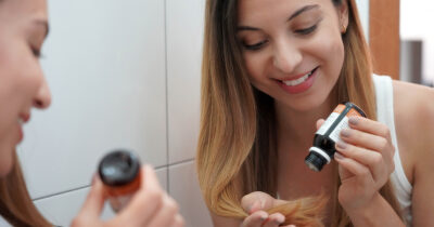 Woman applies oil. Credit / Shutterstock