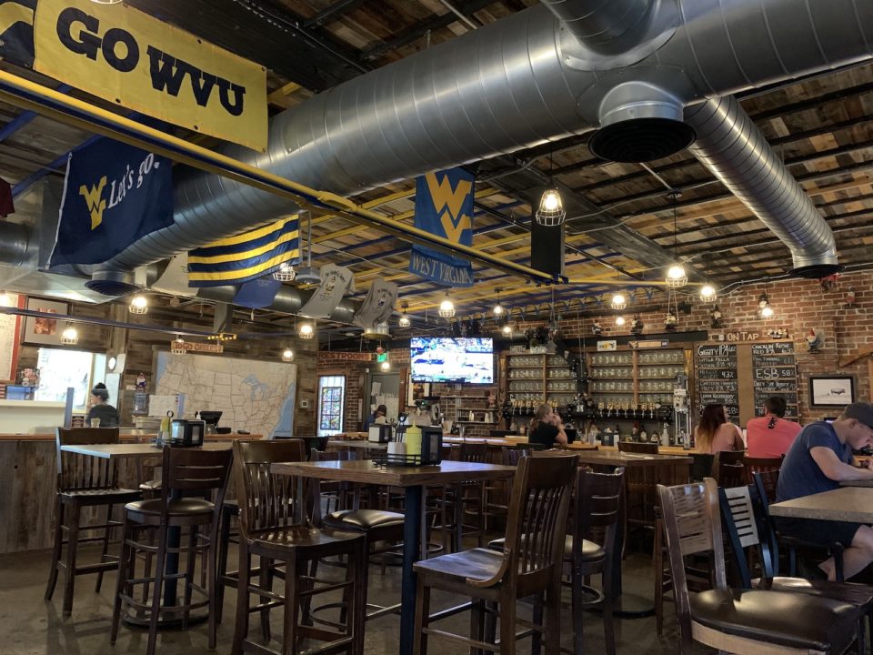 The bar at the Grateful Gnome, decorated with WVU flags