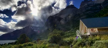 The sun breaks through the clouds over the lodge