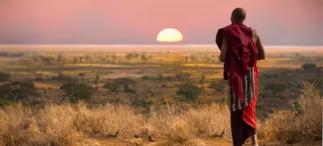 A Maasai warrior walks across the African bush