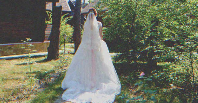 A bride standing in a garden | Source: Shutterstock