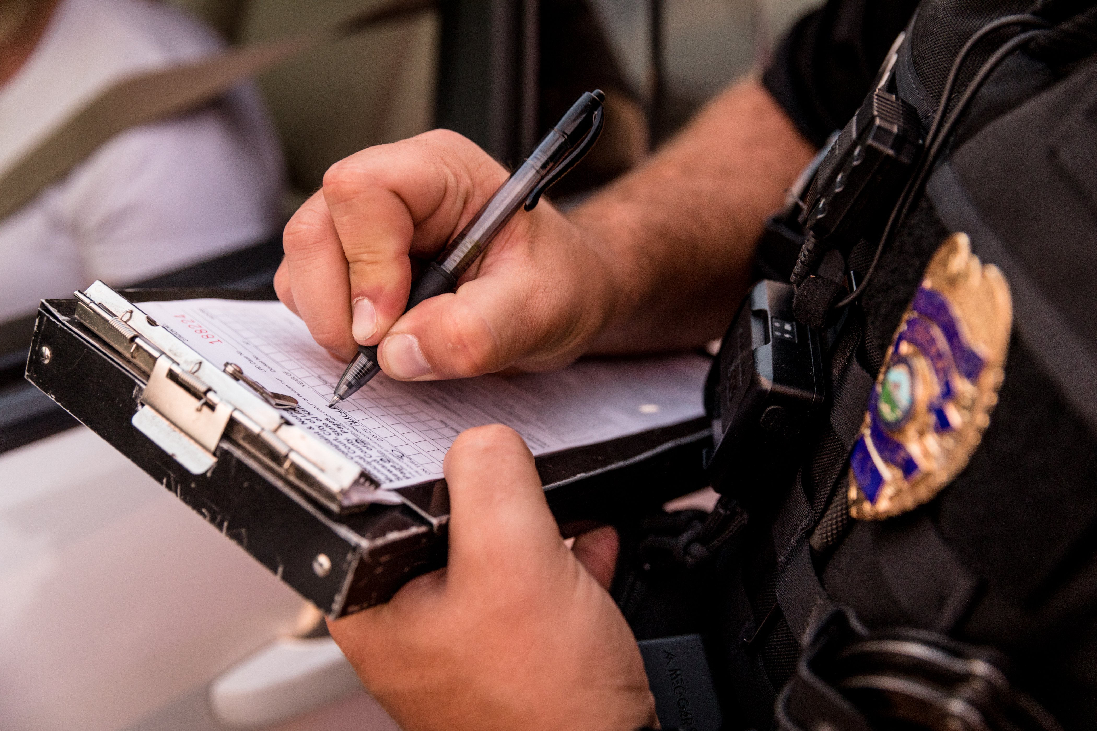 Police officer taking notes. Photo: Shutterstock