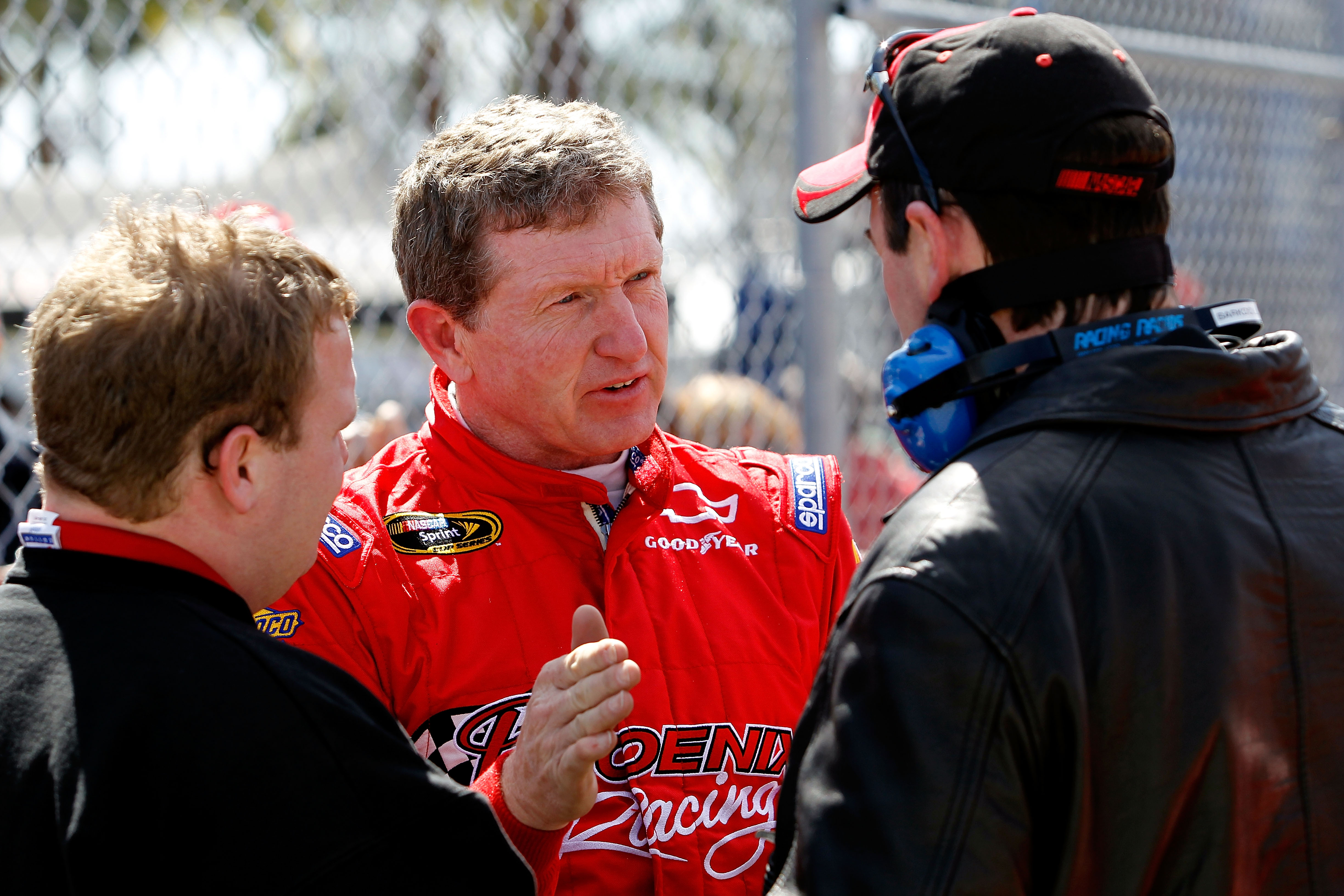 DAYTONA BEACH, FL - FEBRUARY 12:  Bill Elliott, driver of the #09 Phoenix Construction Chevrolet, speaks with crew members during practice for the NASCAR Sprint Cup Series Daytona 500 at Daytona International Speedway on February 12, 2011 in Daytona Beach