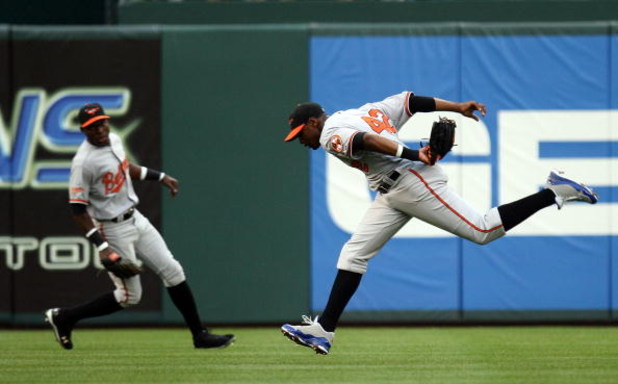 ARLINGTON, TX - APRIL 15:  Centerfielder Adam Jones #10 of the Baltimore Orioles while wearing jersey #42 to commemorate Jackie Robinson day makes the fly out on Hank Blalock of the Texas Rangers on April 15, 2009 at Rangers Ballpark in Arlington, Texas. 