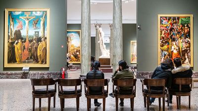 MILAN, ITALY - FEBRUARY 24, 2019: visitors sit in hall in Pinacoteca di Brera (Brera Art Gallery) in Milan. The Brera is national picture gallery of ancient and modern art in Palazzo Brera