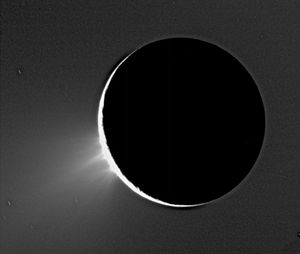 Geysers of ice towering over the south polar region of Enceladus in an image taken by the Cassini spacecraft in 2005. Enceladus is backlit by the Sun.