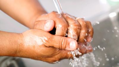 Hand washing. Healthcare worker washing hands in hospital sink under running water. contagious diseases wash hands, handwashing hygiene, virus, human health