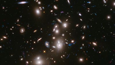 Galaxy clusters like Abell 2744 can act as a natural cosmic lens, magnifying light from more distant, background objects through gravity. NASA's James Webb Space Telescope may be able to detect light from the first stars in the universe if they are gravitationally lensed by such clusters. (astronomy, space exploration, galaxies)