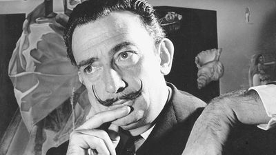 Portrait of Salvador Dali in front of painting "The Madonna of Port Lligat."