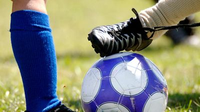 Children kicking soccer ball  (football; sport)