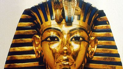 Gold funerary mask of King Tutankhamen, buried in the Valley of the Tombs of the Kings in southern Egypt north of Luxor, 14th century BC. Valley of the Kings. King Tut's Tomb. Funeral mask of King Tutankhamen. King Tut funeral mask. King Tut funerary mask