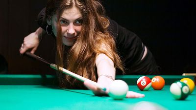 Billiards. Woman playing pool game.