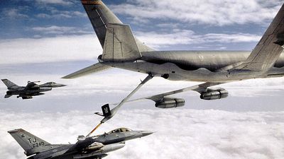 KC-135 Stratotanker refueling U.S. Airforce military F-16 Falcon. Transportation aircraft refueled in mid-air aka aerial refueling.