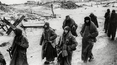 Photo shows captured German soldiers, their uniforms tattered from the battle, making their way in the bitter cold through the ruins of Stalingrad, January 1943. World War II Battle of Stalingrad Russia