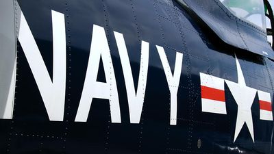 Navy. U.S. Navy markings near the cockpit of a restored vintage aircraft. airplane, aircraft carrier