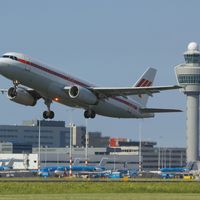 A passenger jetliner taking off from Amsterdam's Schiphol Airport, one of the busiest airports in the world.