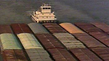 Behold a barge-carrying ship transporting a load down the Mississippi River