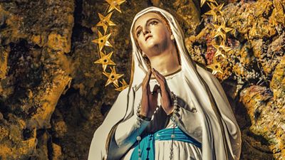 The apparition of the Blessed Virgin Mary surrounded by stars in the grotto of Lourdes