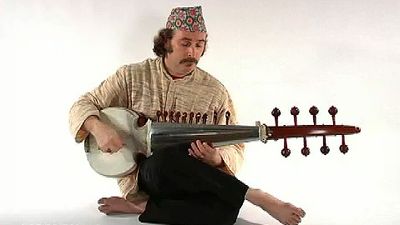 Watch and hear a person playing the sarod, a stringed instrument of Hindustani music