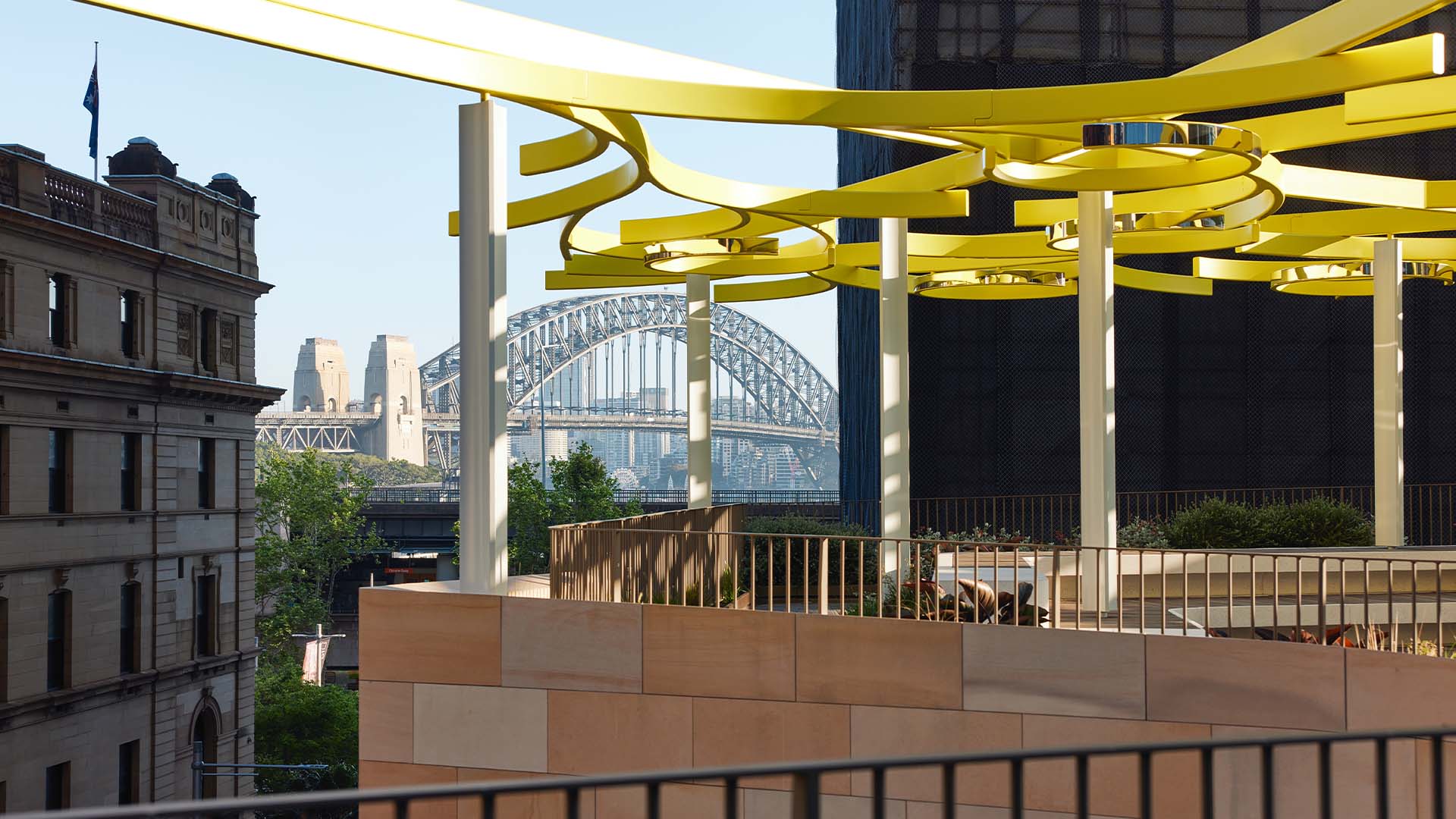 A breezy rooftop bar with the Sydney Harbour Bridge in the background