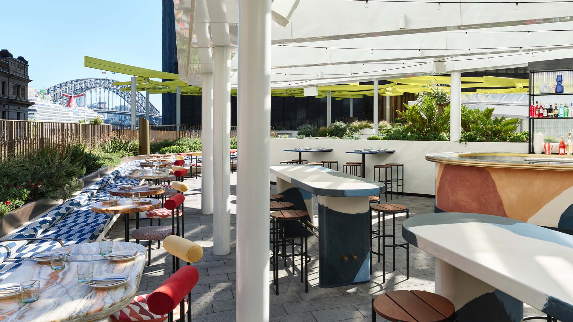 A breezy rooftop bar with the Sydney Harbour Bridge in the background