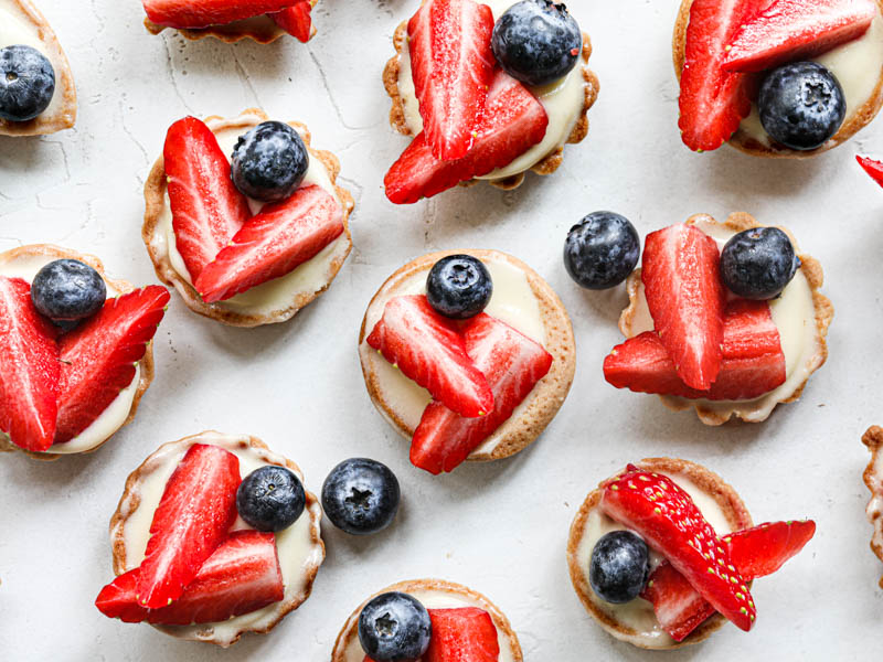 The mini strawberry lemon tartlets arranged in a random manner as seen from above.