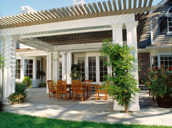 Fabulous trim work of the pergola blends with the facade of the residence