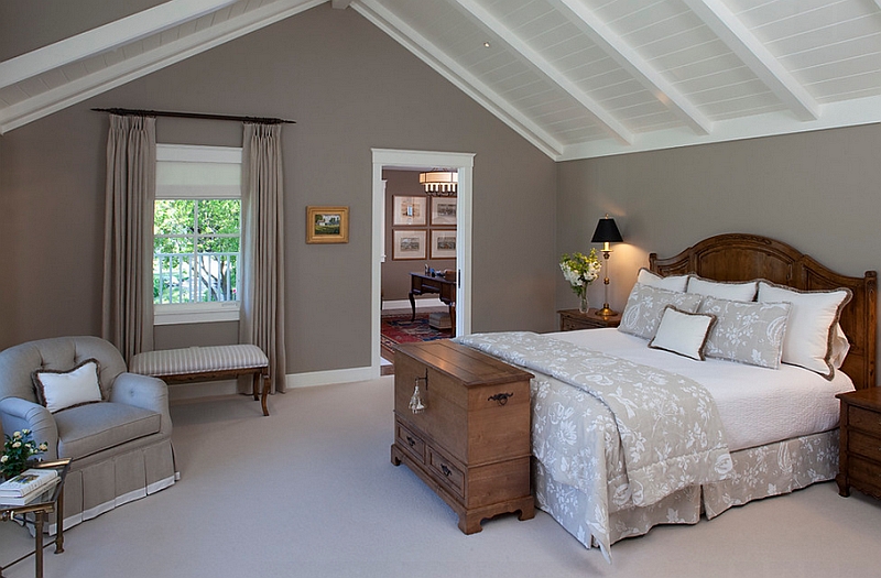 Grey walls of a bedroom with slanted ceiling.