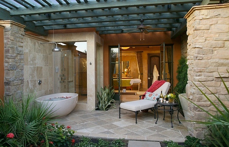 Outdoor bathroom idea with tub and shower adjacent to the bathroom indoors [Design: Concreteworks]