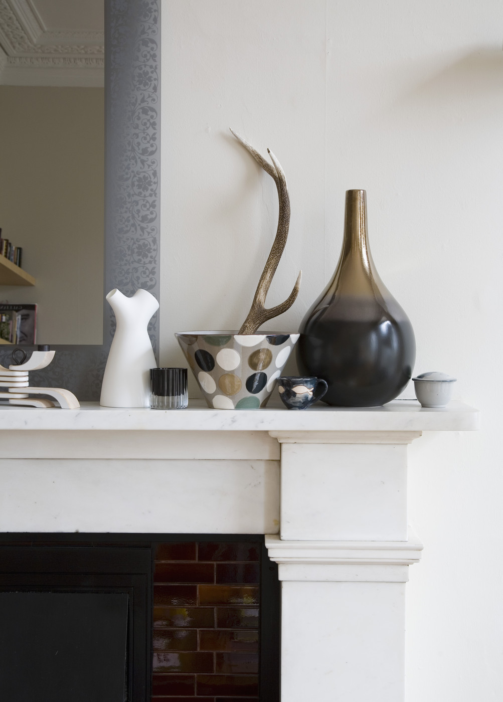 Taupe meets grey on a fireplace mantel