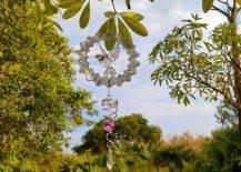 Bird wind spinner hanging from a tree branch