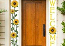 Welcome and sunflower banners on either side of brown door