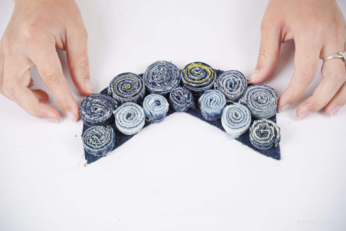 denim rolls lined up on denim base on white table