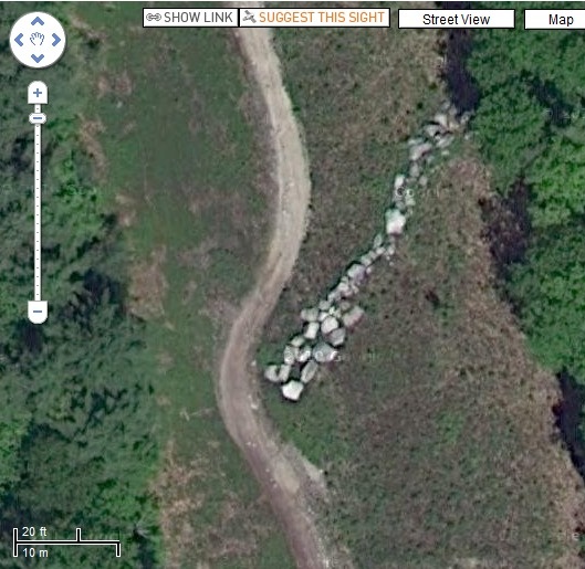 The Google cameras also caught this strange collection of rocks/

This is a strange pointing-style arrow created by arranging piles of stones near Sebago Lake in Cumberland County, Maine.