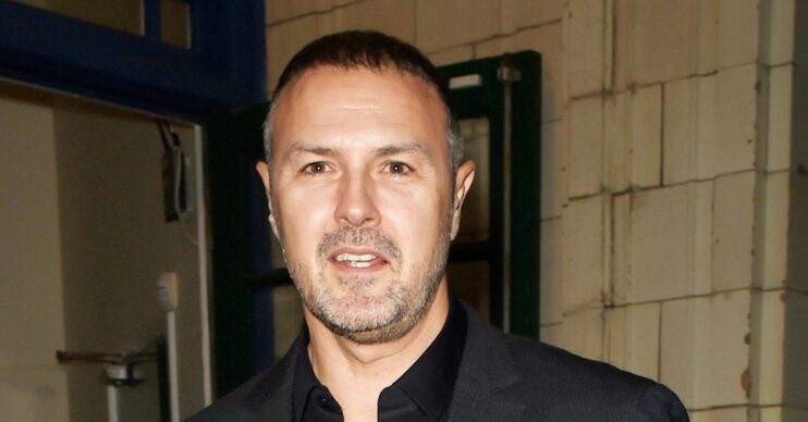 Paddy McGuinness smiles in a black suit